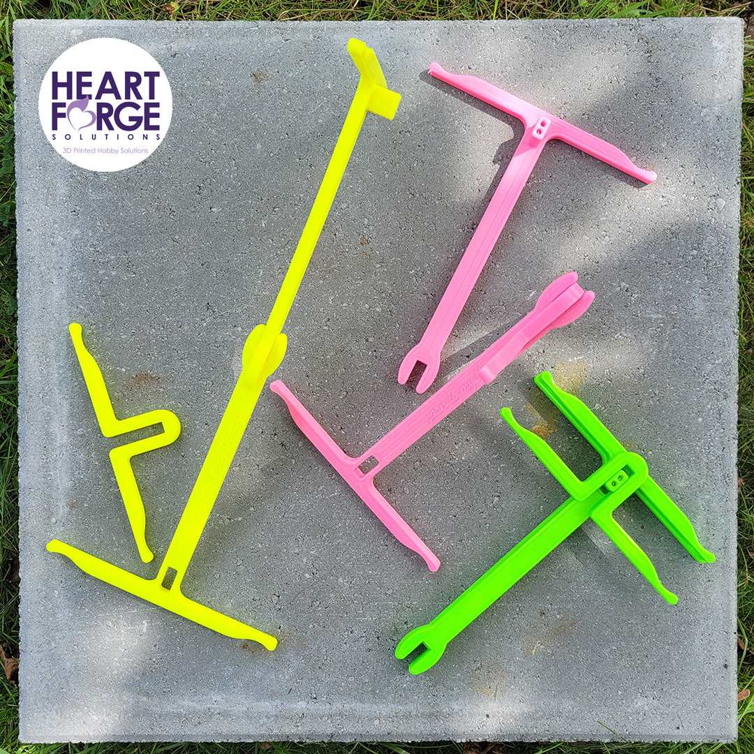 Anna's Niddy Noddy Heart Forge Solutions seen in its 3 configurations. Yellow 2 Yards, Pink 1 Yard, Green packed for storage.