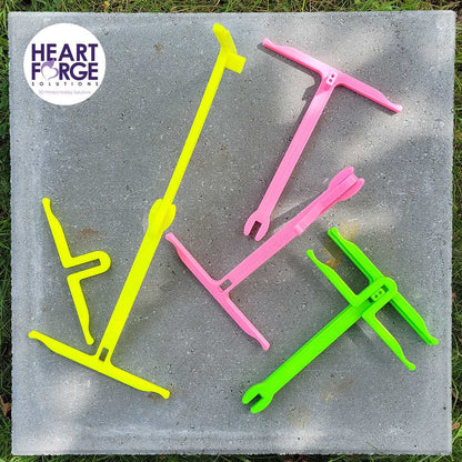 Anna's Niddy Noddy Heart Forge Solutions seen in its 3 configurations. Yellow 2 Yards, Pink 1 Yard, Green packed for storage.